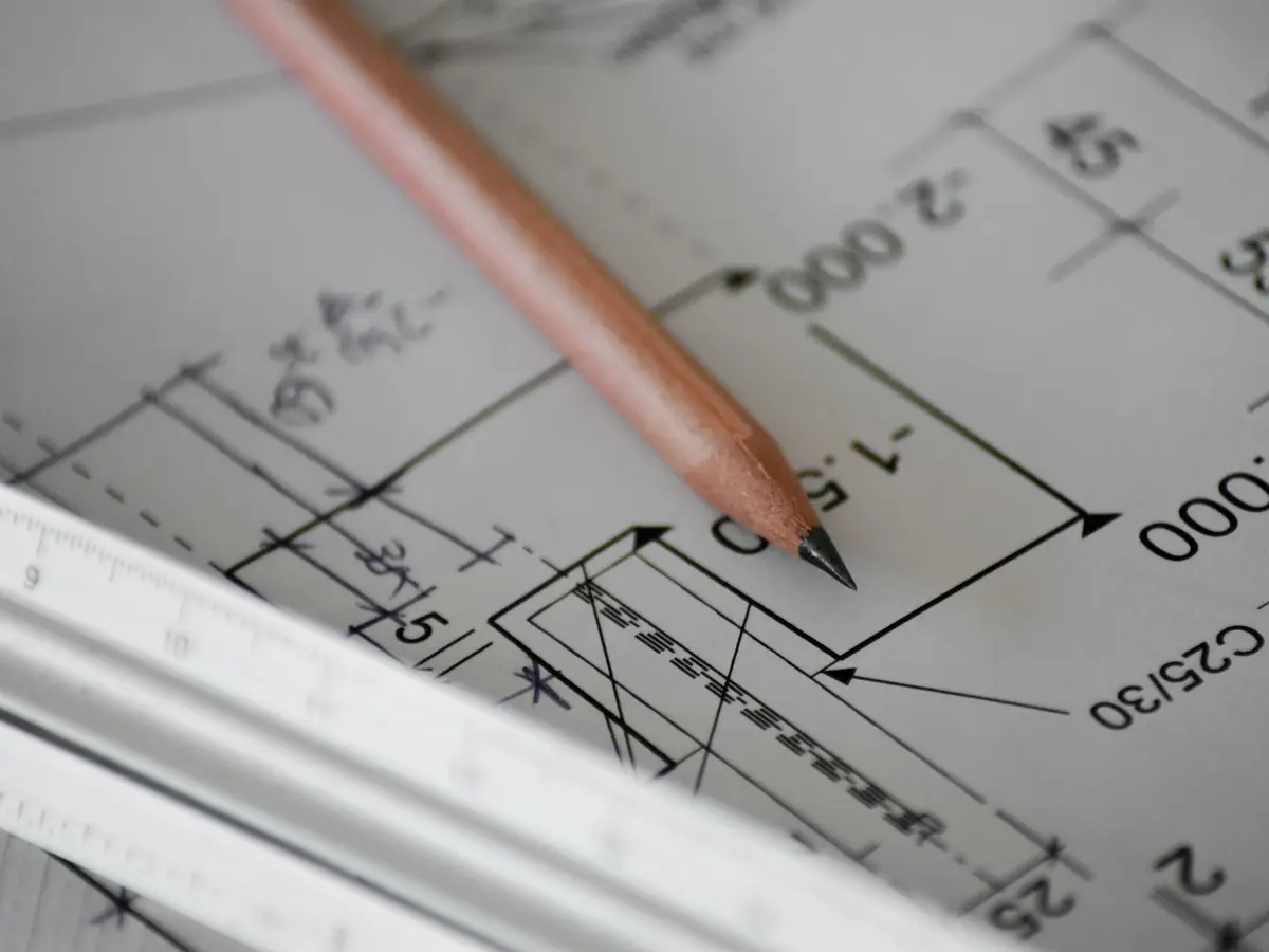 A pencil resting on building plans