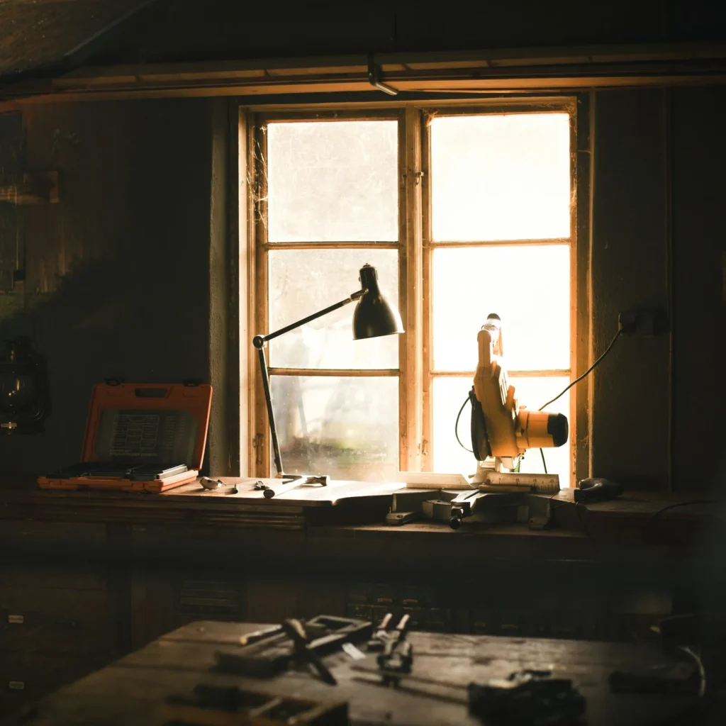 A quiet workshop bench by a window, after hours