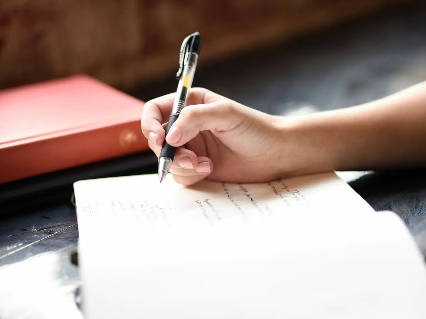 A hand writing notes in a notebook